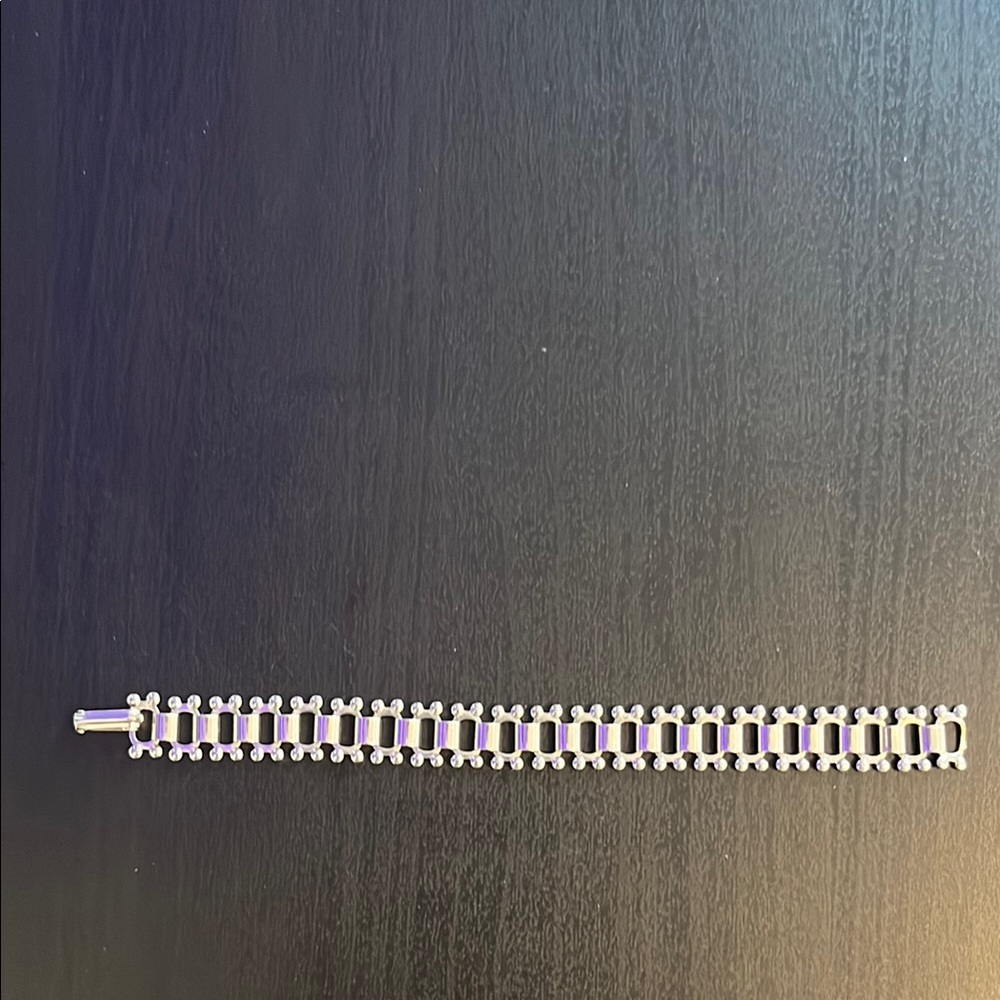 Silver tone link bracelet.